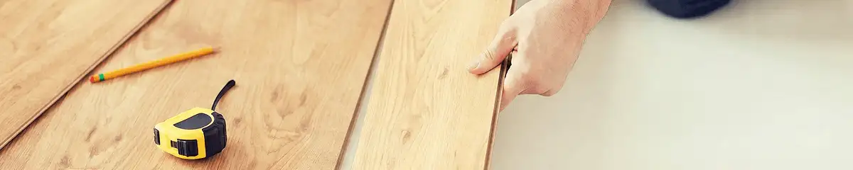 A professional installing wood flooring in Fresno, CA