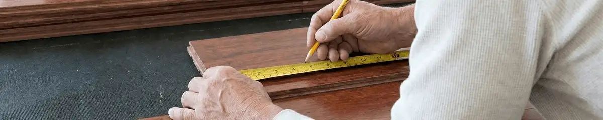A professional installing wood flooring in Fresno, CA